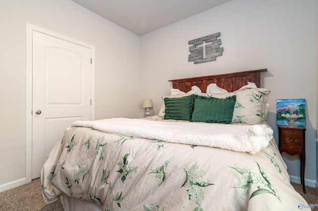 carpeted bedroom featuring baseboards