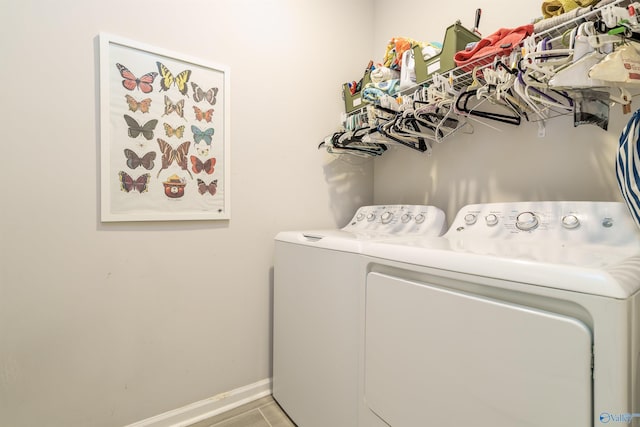 laundry room with laundry area, washing machine and dryer, and baseboards