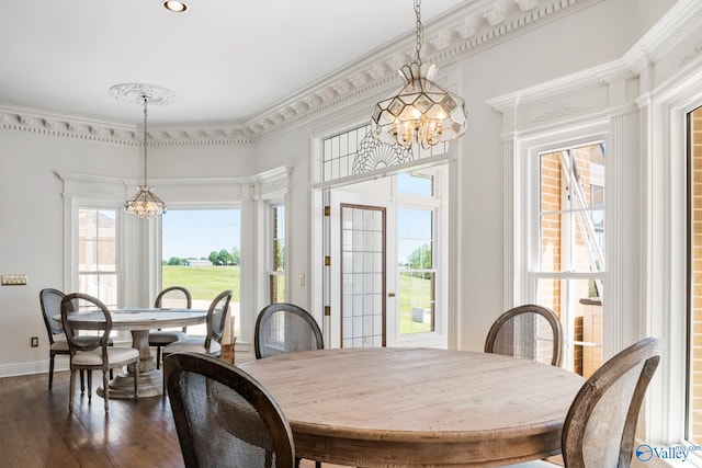 dining room with an inviting chandelier, hardwood / wood-style floors, and a healthy amount of sunlight