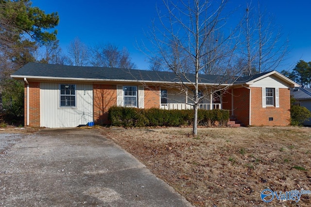 single story home with crawl space, driveway, a porch, and brick siding