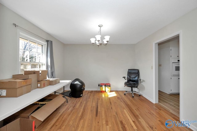 interior space featuring a notable chandelier, baseboards, and wood finished floors