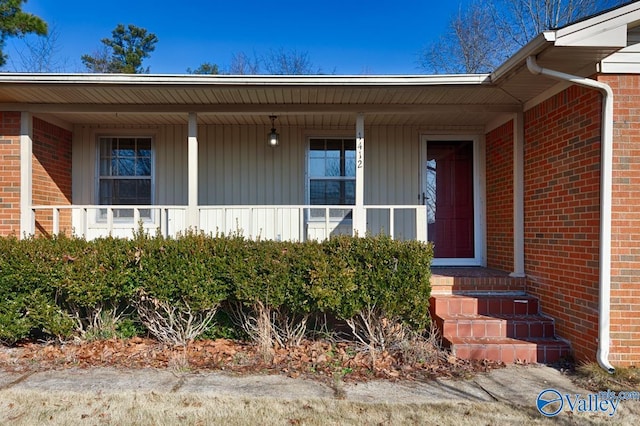 view of exterior entry with brick siding