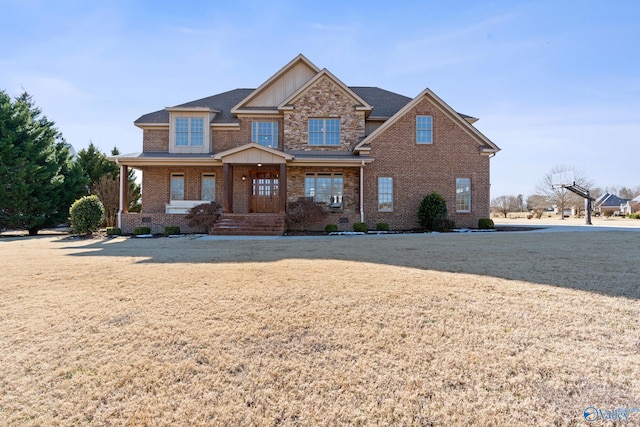 view of front of house with a porch and a front lawn