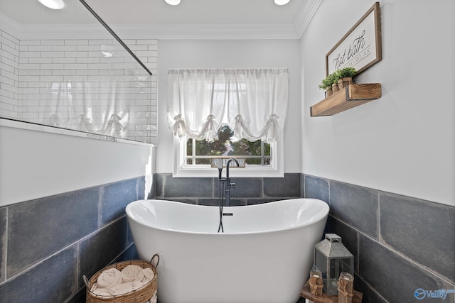 bathroom with tile walls, a bathtub, and crown molding