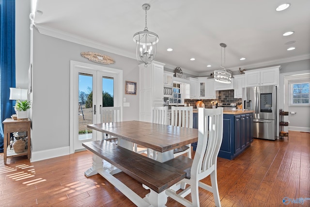 dining space with french doors, a wealth of natural light, crown molding, and hardwood / wood-style flooring