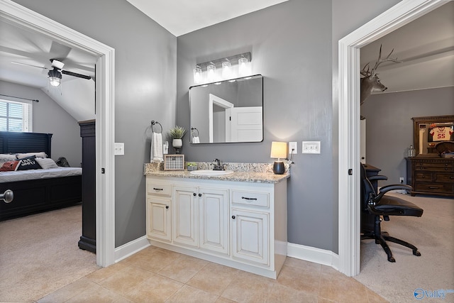 bathroom with vanity, ceiling fan, tile patterned flooring, and lofted ceiling