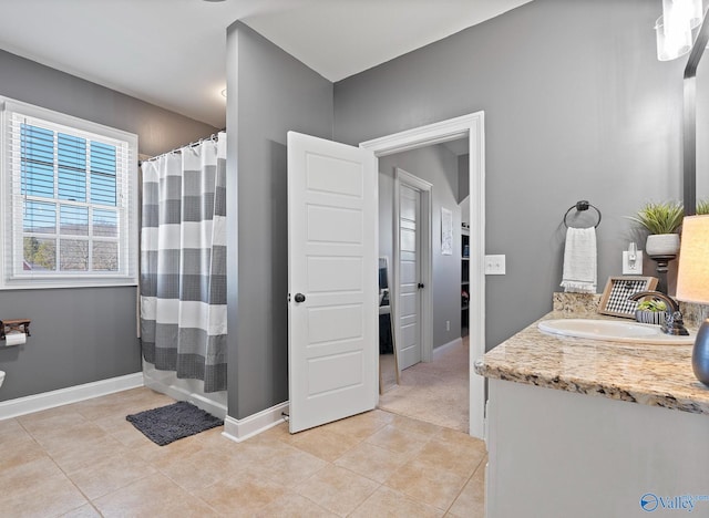 bathroom with a shower with curtain, tile patterned floors, and vanity