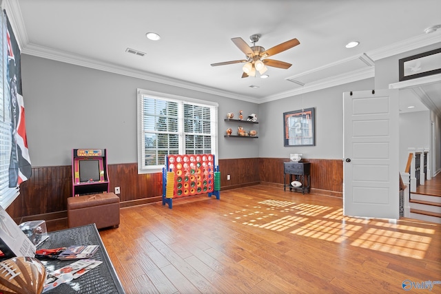 interior space featuring hardwood / wood-style flooring, crown molding, and ceiling fan