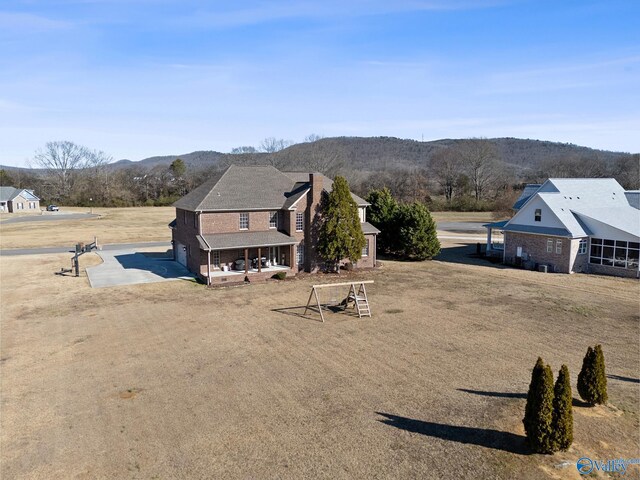 view of front of property featuring a mountain view and covered porch