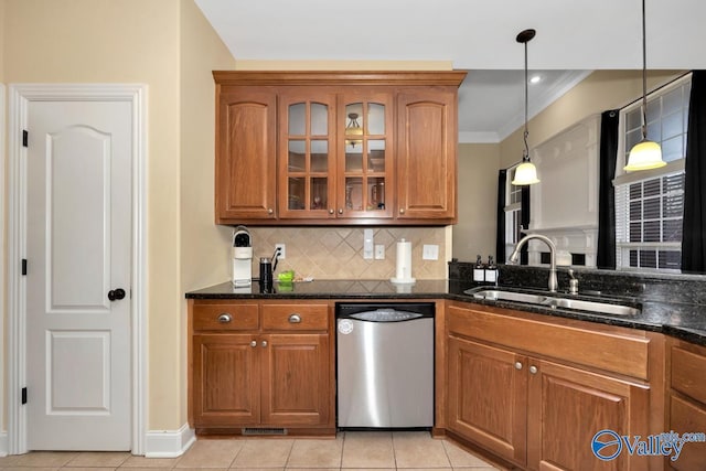 kitchen featuring dark stone countertops, dishwasher, pendant lighting, and sink