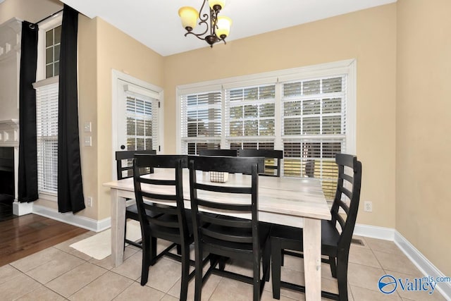 dining room featuring an inviting chandelier and light tile patterned flooring