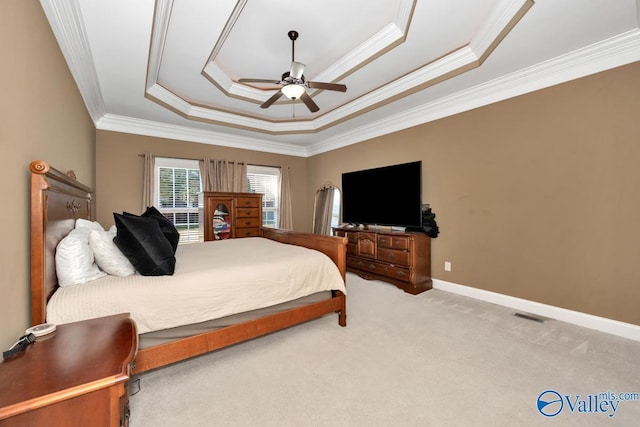 bedroom with ceiling fan, a raised ceiling, carpet floors, and crown molding