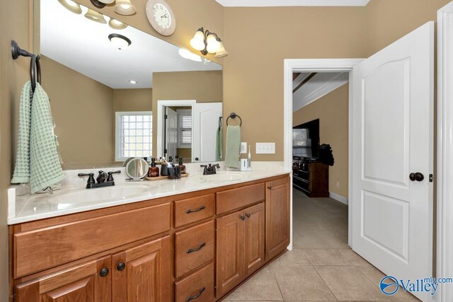 bathroom with tile patterned flooring, vanity, and crown molding