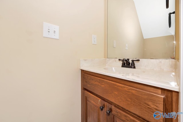 bathroom featuring vanity and vaulted ceiling