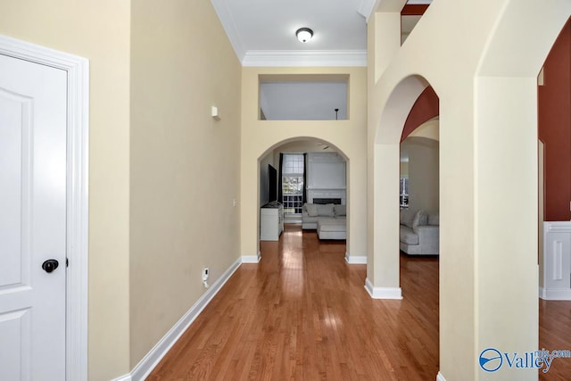 corridor featuring hardwood / wood-style flooring and crown molding