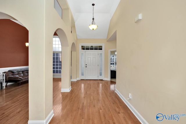 entryway featuring light hardwood / wood-style flooring and high vaulted ceiling