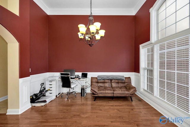 home office featuring crown molding, hardwood / wood-style floors, and an inviting chandelier