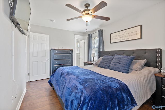 bedroom featuring wood finished floors, baseboards, and a ceiling fan