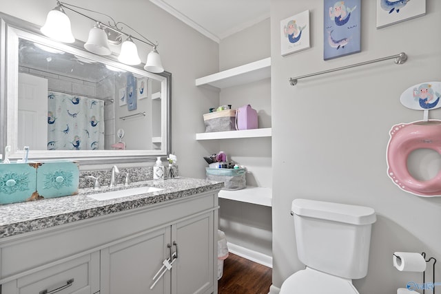 bathroom with vanity, a shower with curtain, ornamental molding, toilet, and wood finished floors