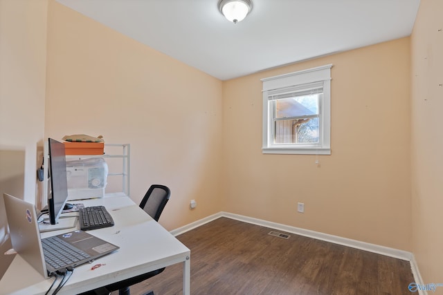office area featuring visible vents, baseboards, and wood finished floors