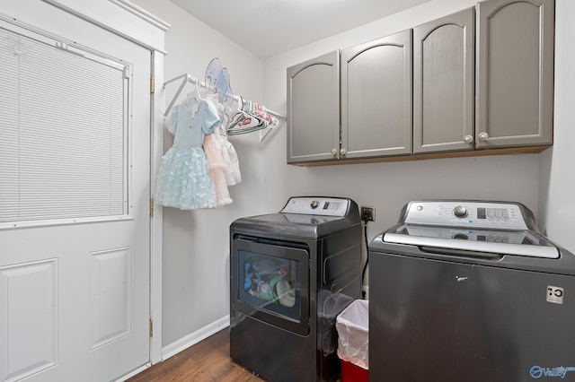 washroom featuring cabinet space, baseboards, dark wood-type flooring, and separate washer and dryer