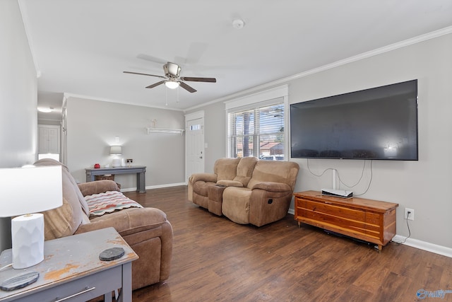 living area featuring dark wood-type flooring, baseboards, ornamental molding, and ceiling fan