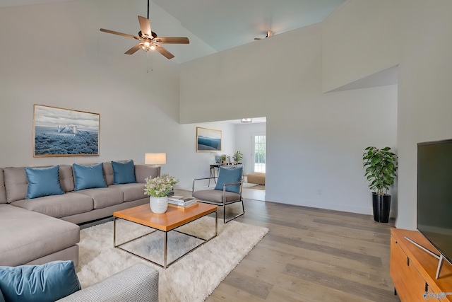 living room with high vaulted ceiling, light hardwood / wood-style floors, and ceiling fan