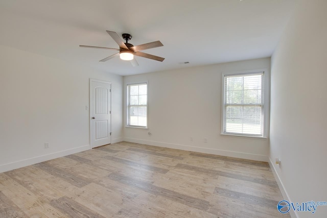 empty room featuring ceiling fan and light wood-type flooring