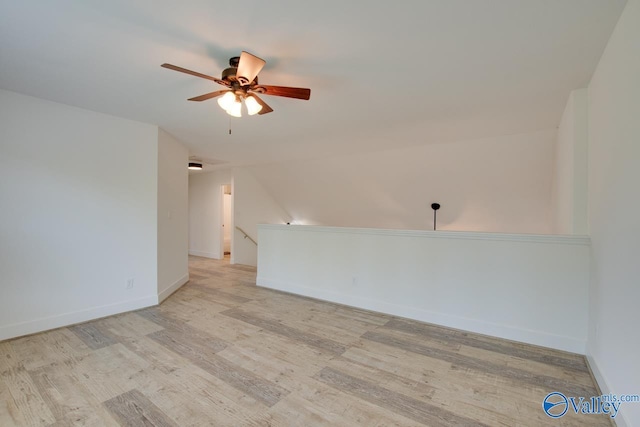 spare room with vaulted ceiling, ceiling fan, and light hardwood / wood-style floors