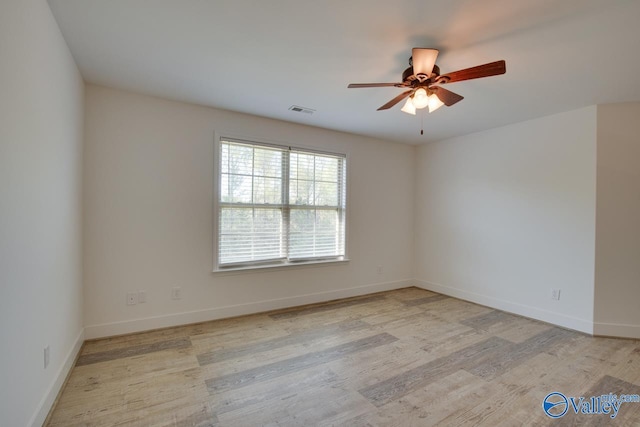 empty room featuring ceiling fan and light wood-type flooring