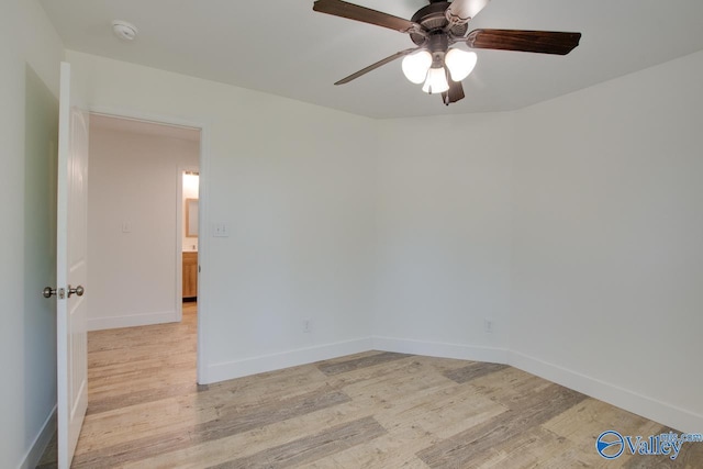 spare room featuring light hardwood / wood-style flooring and ceiling fan