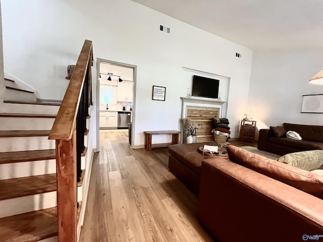 229 Crawford Rd, Scottsboro, AL 35769 - living room with stairway, visible vents, and light wood-style flooring