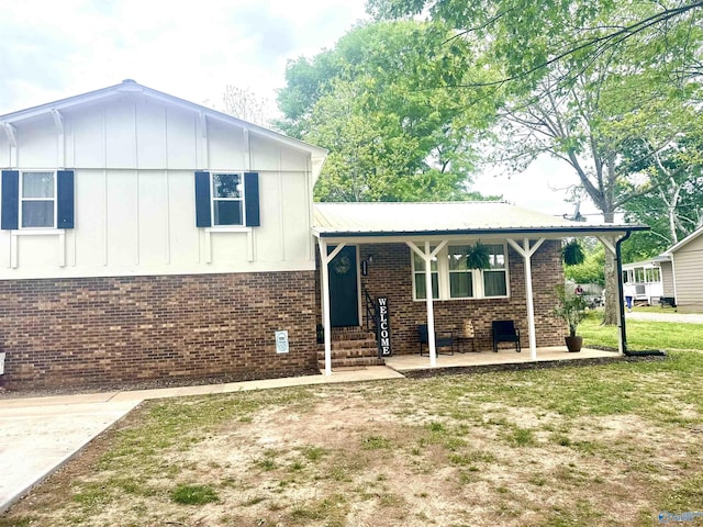 229 Crawford Rd, Scottsboro, AL 35769 - split level home featuring board and batten siding, covered porch, and brick siding