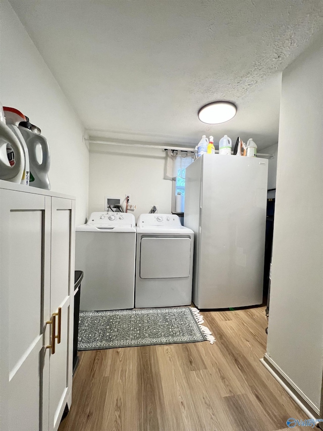 229 Crawford Rd, Scottsboro, AL 35769 - laundry area with a textured ceiling, wood finished floors, laundry area, and independent washer and dryer