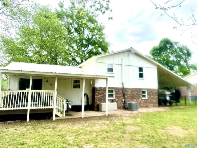 229 Crawford Rd, Scottsboro, AL 35769 - rear view of property featuring central AC, a wooden deck, brick siding, and a yard