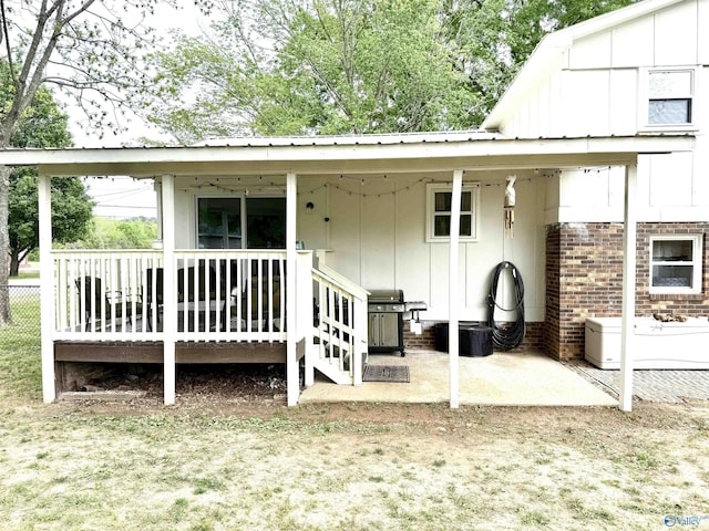 229 Crawford Rd, Scottsboro, AL 35769 - back of house featuring brick siding, fence, and metal roof