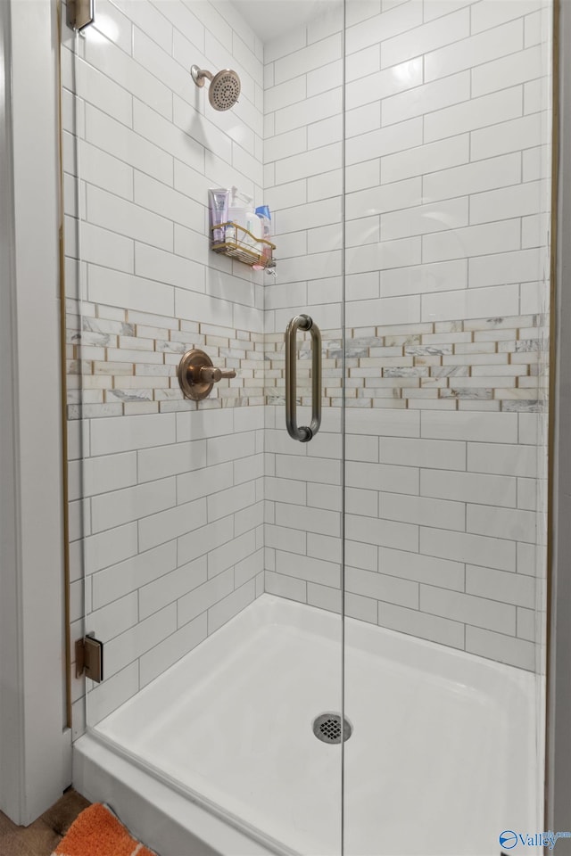 bathroom featuring a shower with door