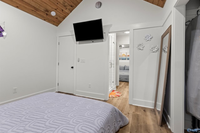 bedroom featuring light wood-type flooring, lofted ceiling, and wooden ceiling