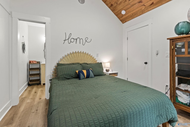 bedroom with light wood-type flooring, wood ceiling, and vaulted ceiling