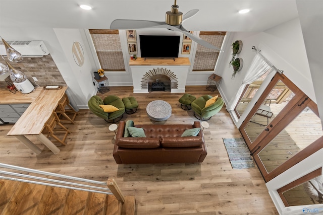 living room with hardwood / wood-style flooring and ceiling fan