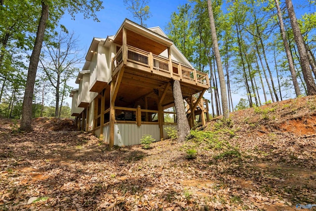 back of house featuring a wooden deck