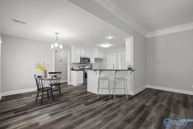 2624 Bransford Trl, Owens Cross Roads, AL 35763 - kitchen featuring appliances with stainless steel finishes, dark countertops, white cabinets, dark wood-style flooring, and baseboards