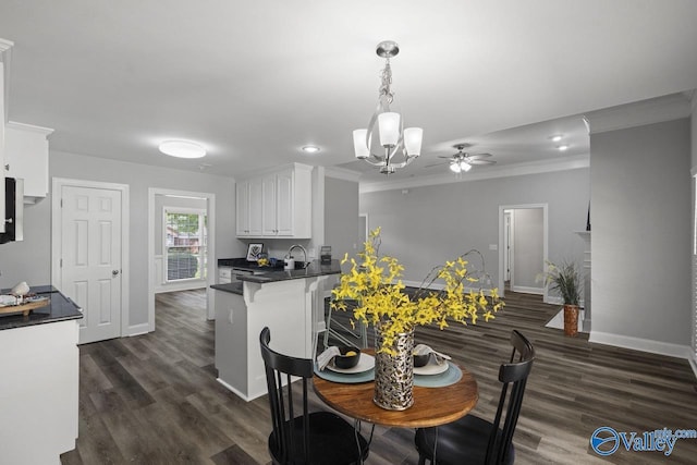 2624 Bransford Trl, Owens Cross Roads, AL 35763 - dining space with ornamental molding, baseboards, dark wood-style floors, a chandelier, and a ceiling fan