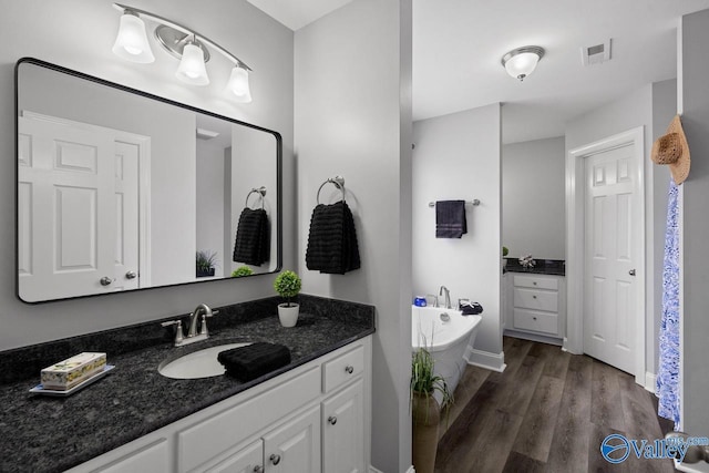 2624 Bransford Trl, Owens Cross Roads, AL 35763 - full bathroom with vanity, wood finished floors, and a garden tub