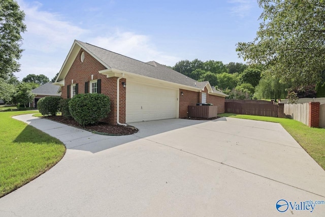 2624 Bransford Trl, Owens Cross Roads, AL 35763 - view of side of property with brick siding, driveway, an attached garage, central AC, and roof with shingles
