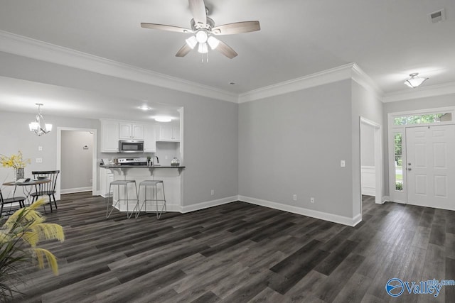 2624 Bransford Trl, Owens Cross Roads, AL 35763 - unfurnished living room with dark wood-style flooring, ornamental molding, a ceiling fan, baseboards, and a chandelier
