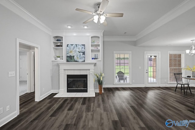 2624 Bransford Trl, Owens Cross Roads, AL 35763 - unfurnished living room with wood finished floors, baseboards, a tile fireplace, ornamental molding, and a chandelier