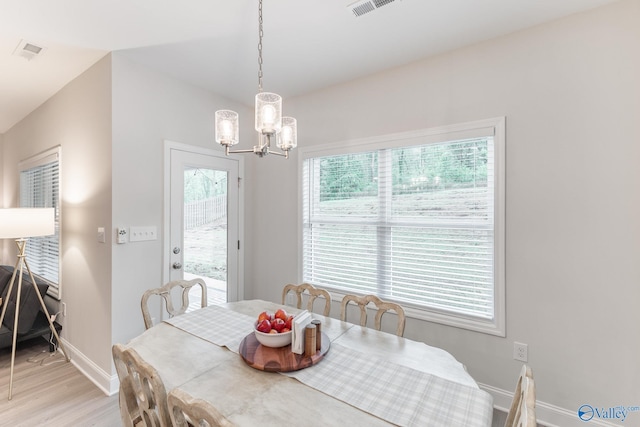 4018 SE Rockland Cir, Owens Cross Roads, AL 35763 - dining area featuring baseboards, a chandelier, and light wood-style flooring