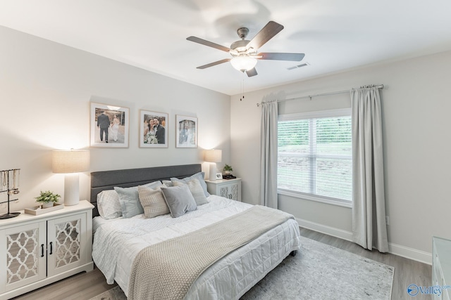 4018 SE Rockland Cir, Owens Cross Roads, AL 35763 - bedroom featuring light wood-type flooring, baseboards, and ceiling fan