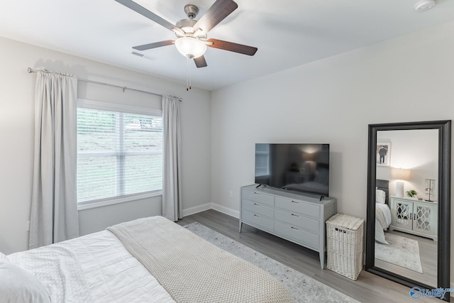 4018 SE Rockland Cir, Owens Cross Roads, AL 35763 - bedroom with wood finished floors, baseboards, and a ceiling fan